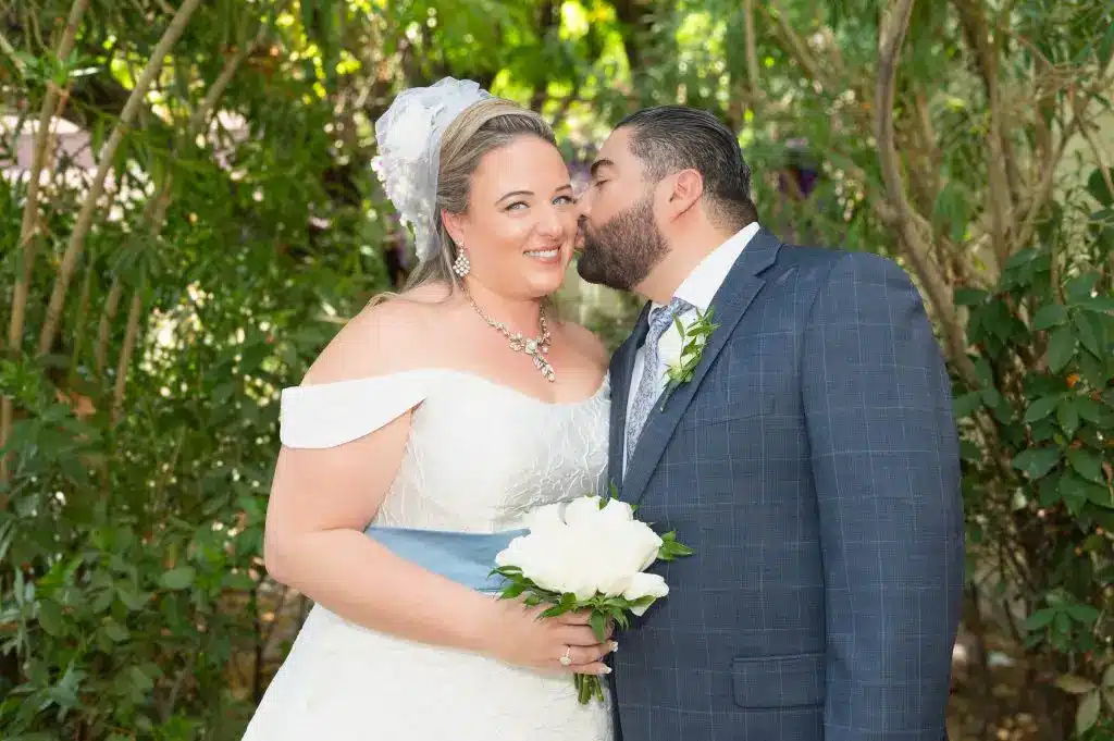 Romantic sunset kiss after a Las Vegas outdoor wedding ceremony