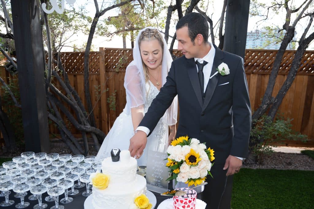 Romantic wedding cake cutting moment at Mon Bel Ami Wedding Chapel reception area.